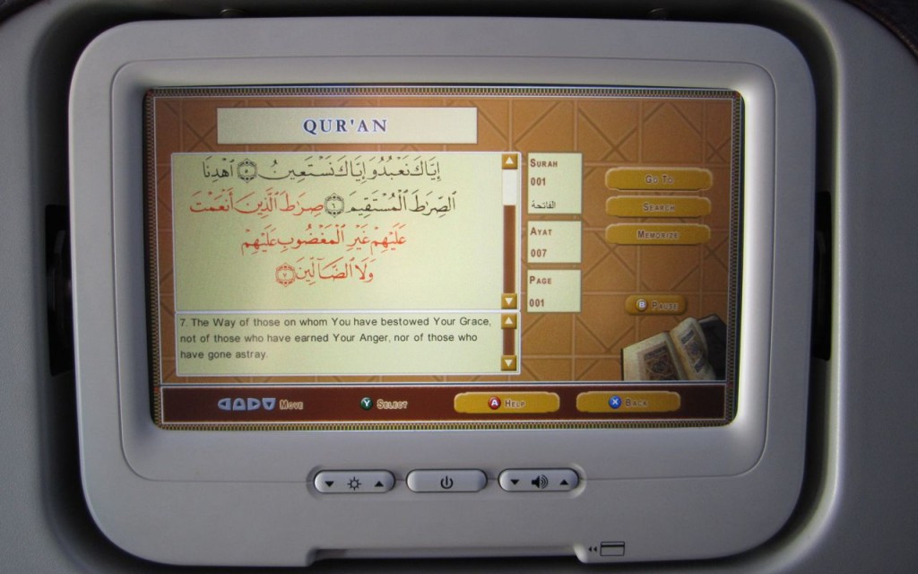 Digital Reader for the Qur'an in the back of an airplane seat.