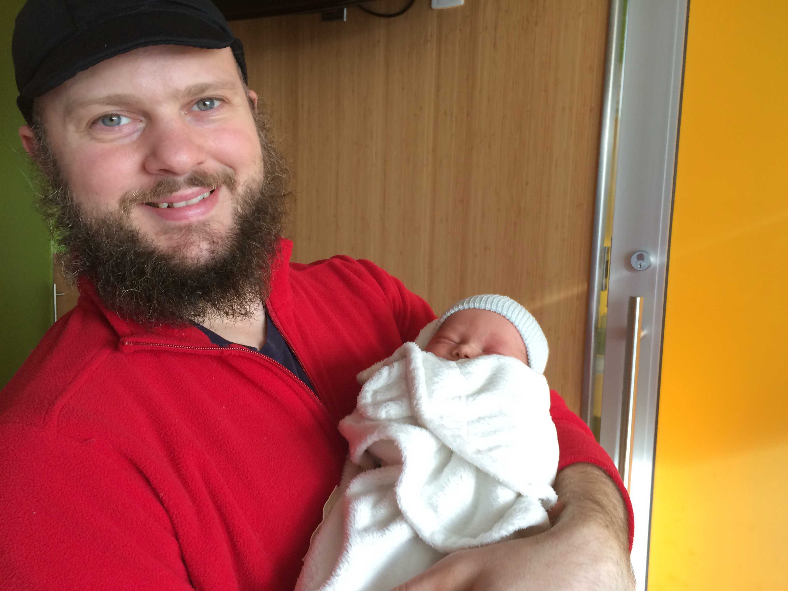 Me holding my newborn nephew while wearing my swrve hat